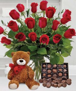 Say 'I Love You' with this sure-fire combination. One dozen long-stemmed, premium, beautiful red roses arranged with a lovable teddy bear, chocolate truffles, and a theme balloon accent!