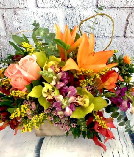 Every farm-girl loves a Harvest Moon! This floral creation is a modern twist to a traditional centerpiece and is designed with our favorite orange Lilies, purple Snapdragons, green Orchids, and other botanical beauties. A fabulous conversation starter and an even better centerpiece.